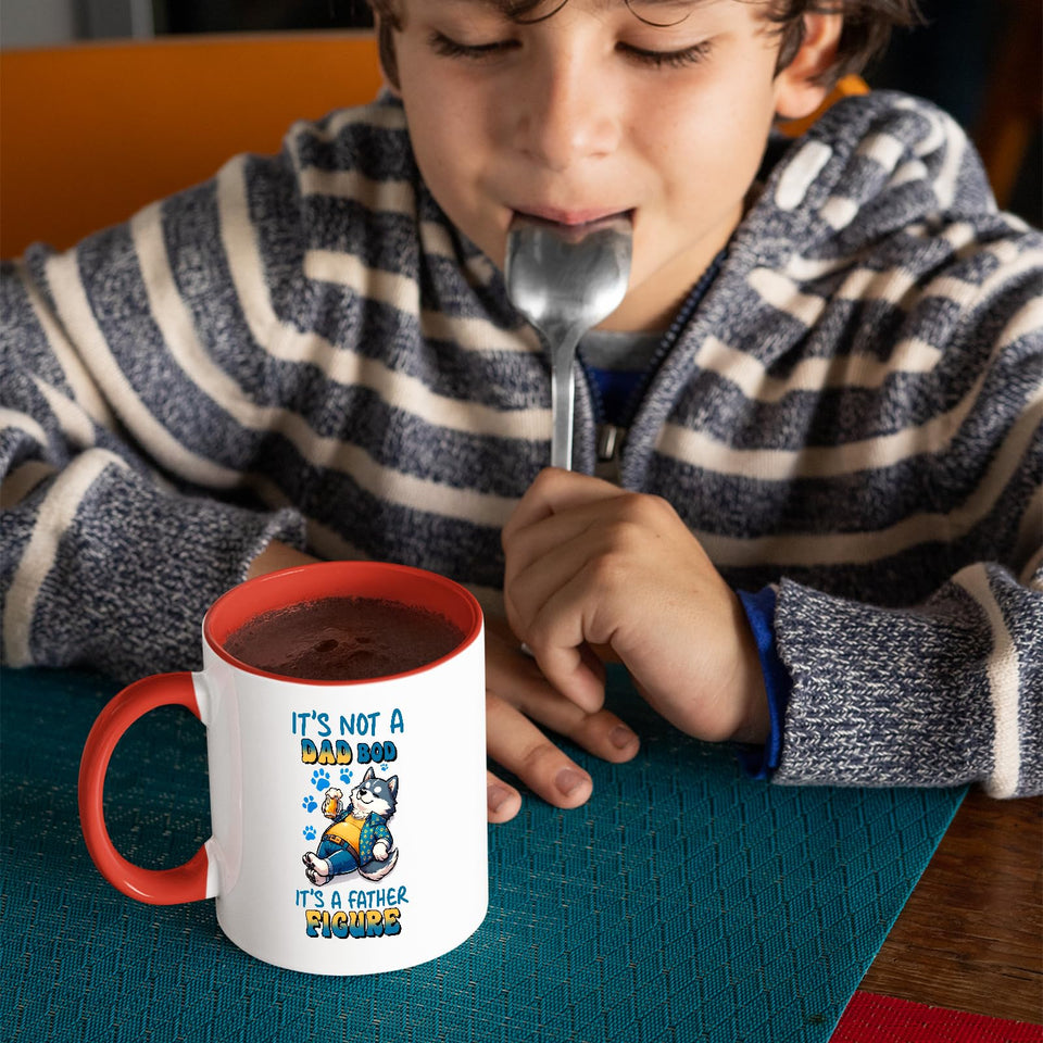 Child with a spoon next to the Dad Bod husky mug with a red handle