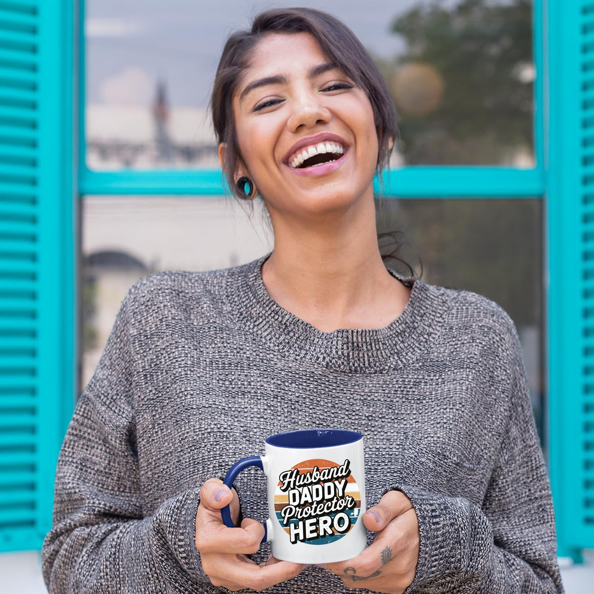Laughing woman holding the Husband Daddy Protector Hero retro mug with a dark blue handle