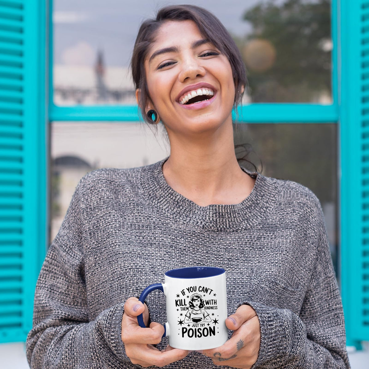 Laughing woman holding the Just Try Poison mug with a dark blue handle