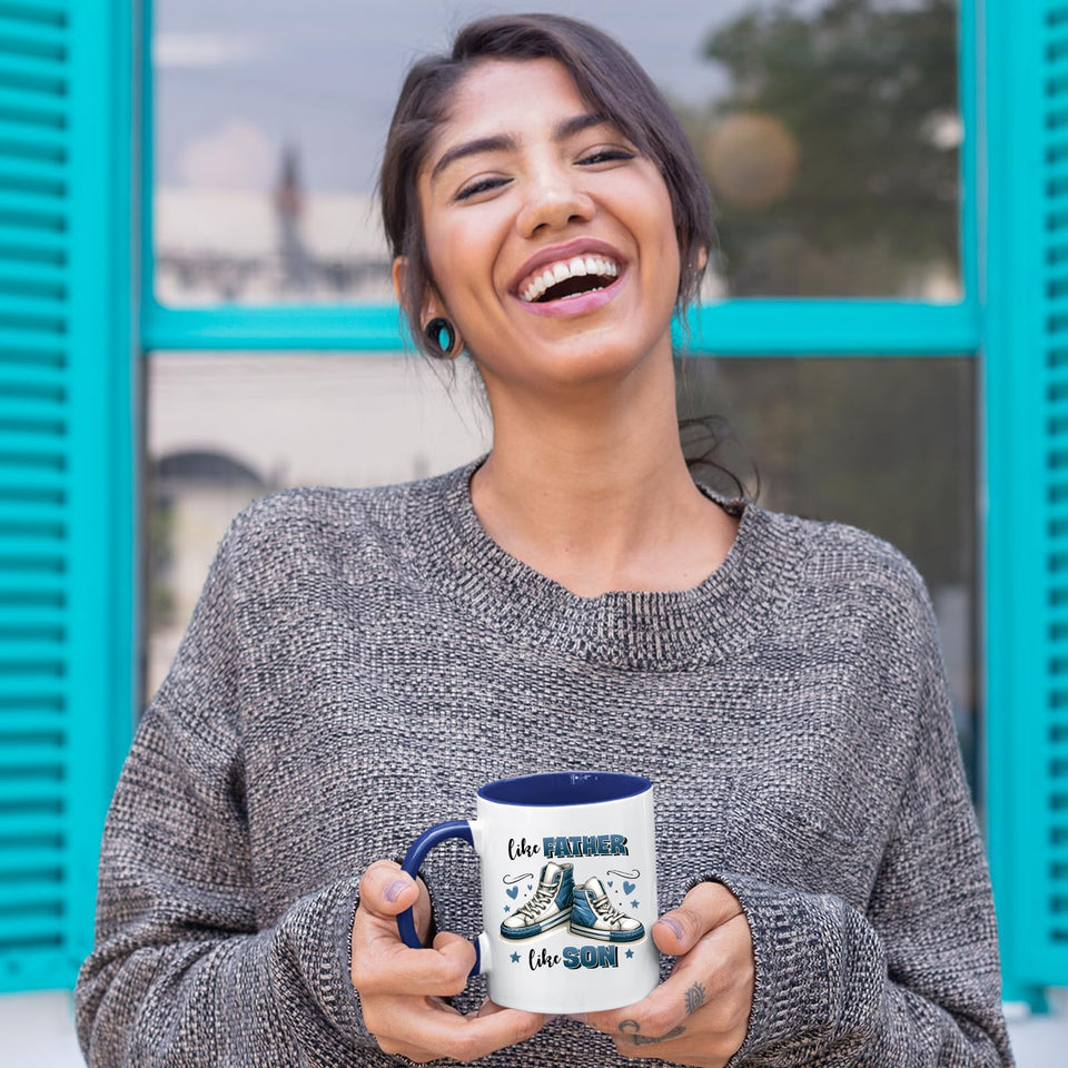 Laughing woman holding the Like Father Like Son mug with a dark blue handle