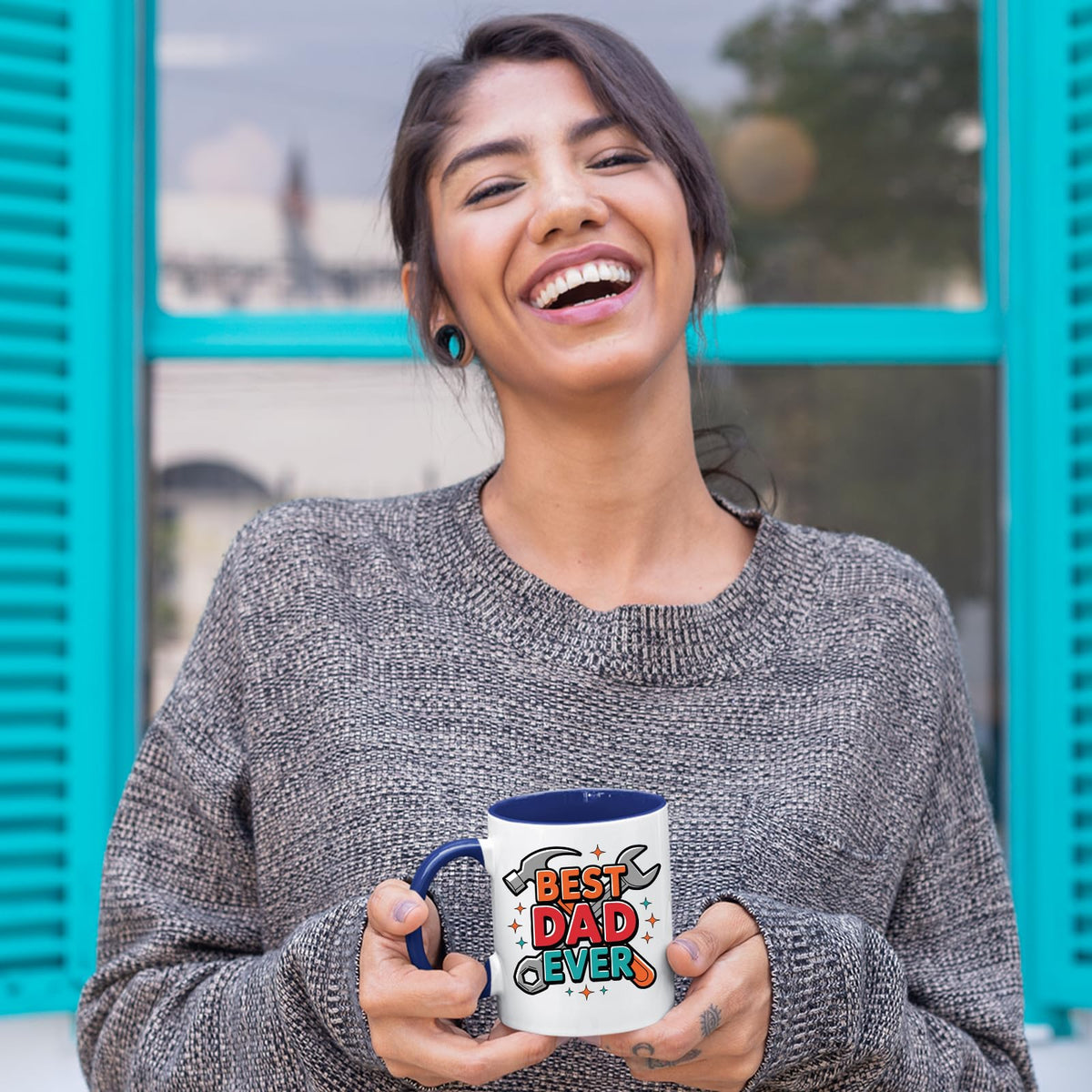 Laughing woman holding the Best Dad Ever tools mug with a dark blue handle
