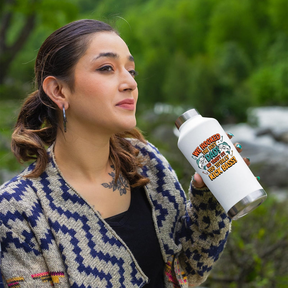 Woman outdoors holding the We Hooked the Best Dad water bottle