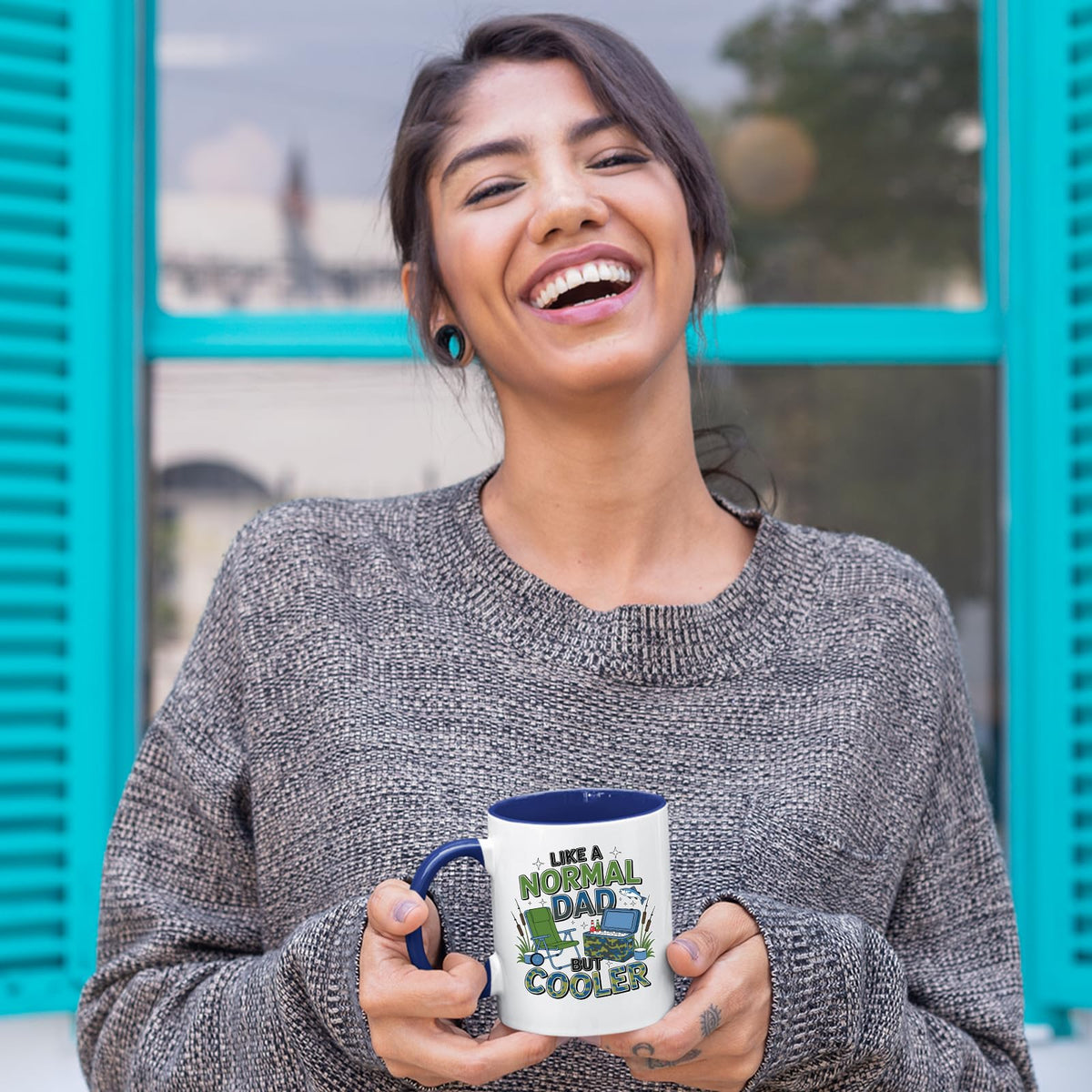 Laughing woman holding the Like a Normal Dad But Cooler mug with a dark blue handle