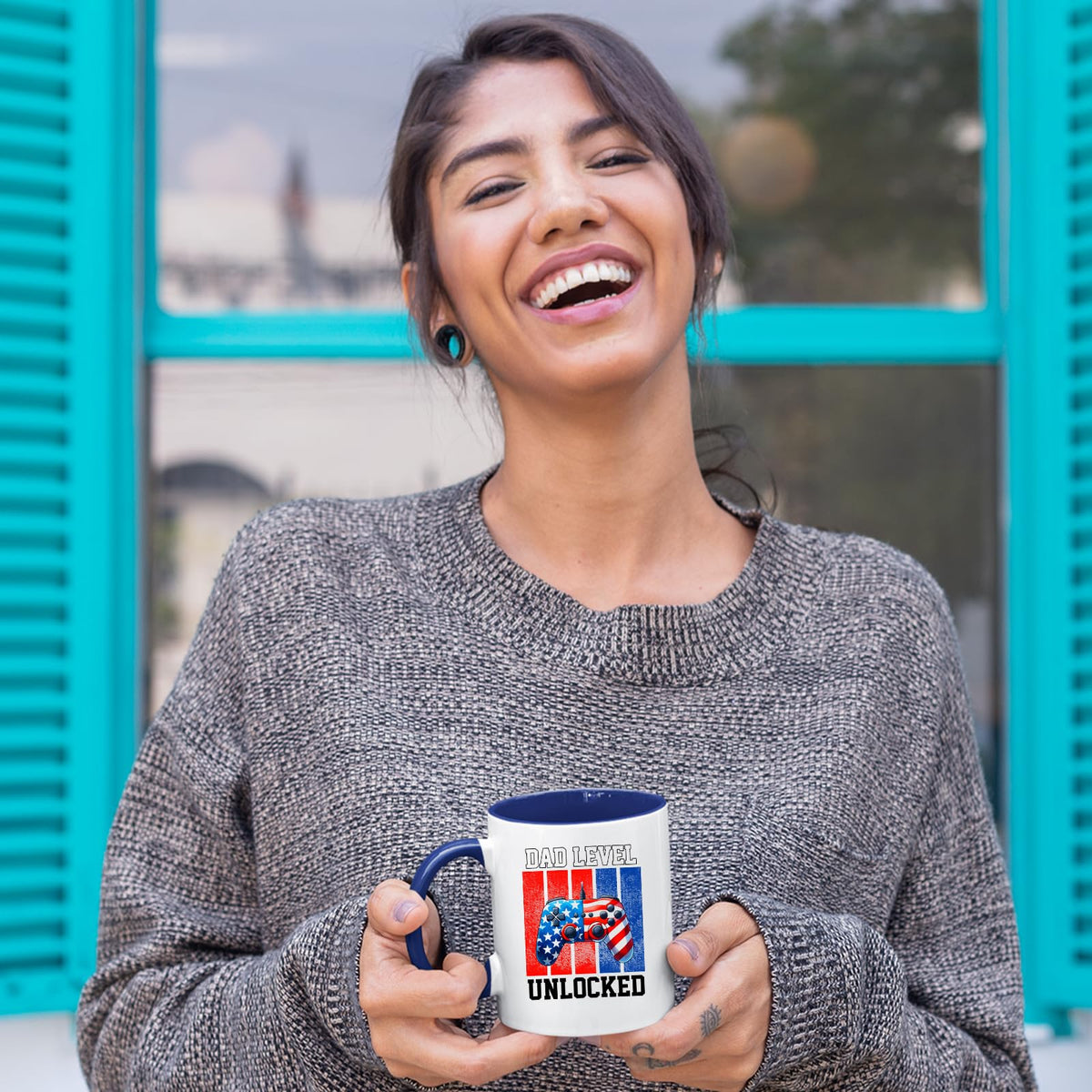 Laughing woman holding the Dad Level Unlocked mug with a dark blue handle