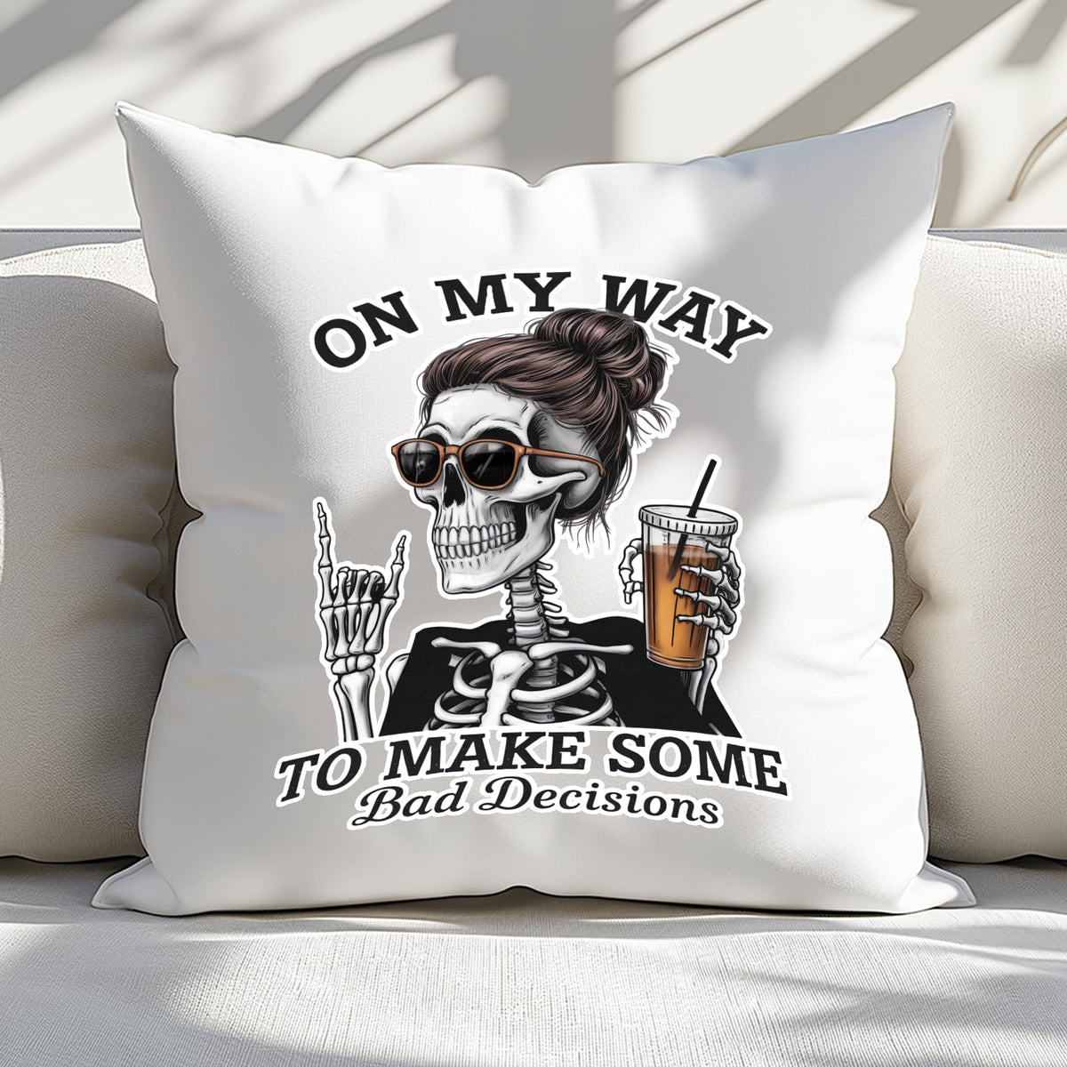 Bad Decisions skeleton cushion on a white sofa