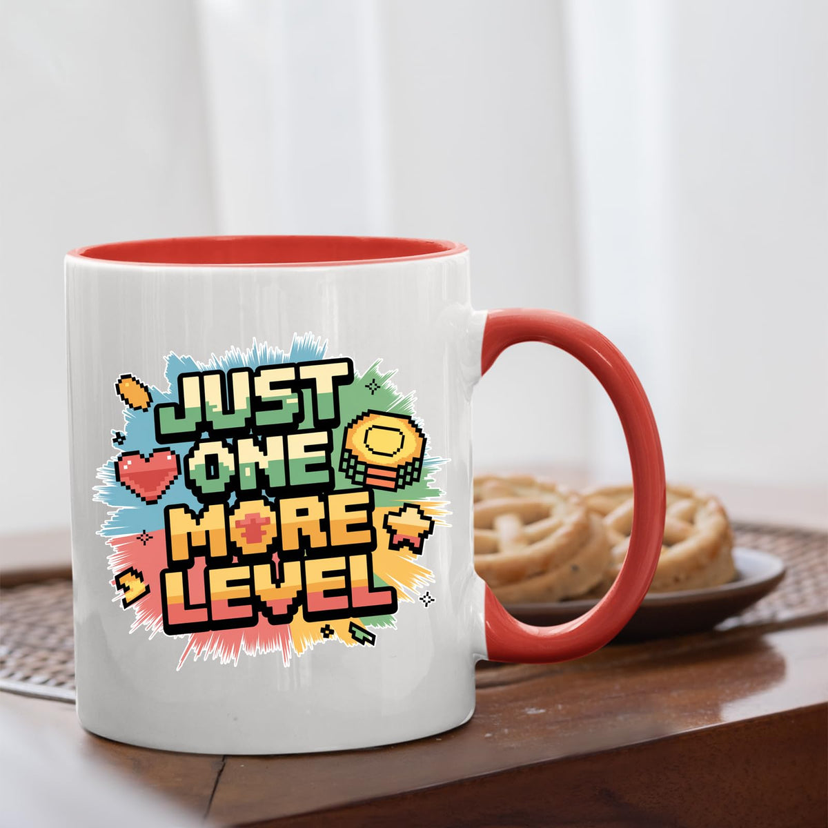 Mug with a red handle beside biscuits