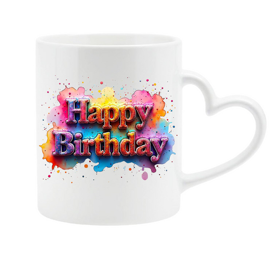 Hands holding the heart-handle mug with pastel splash “Happy Birthday” lettering
