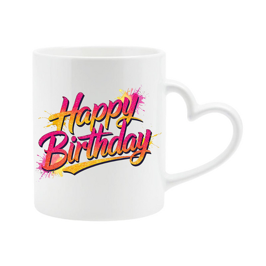 White heart-handle mug with pink and yellow script “Happy Birthday” lettering