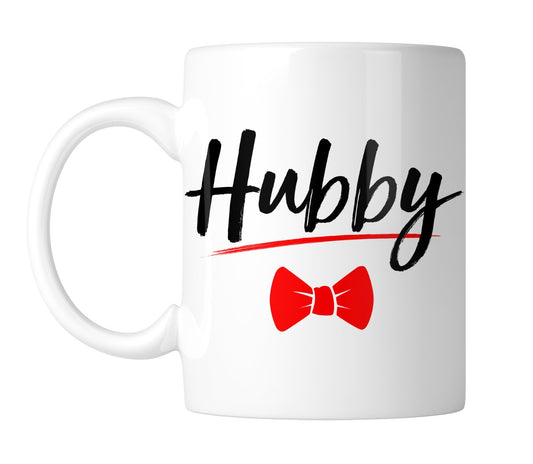 White mug with “Hubby” in black script with a red bow tie, handle on the left
