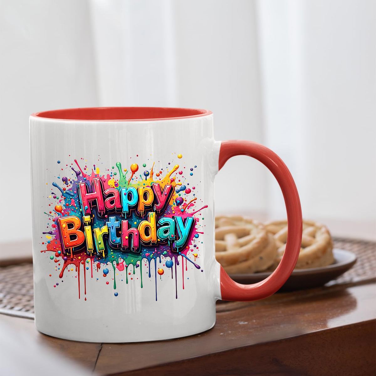 Mug with a red handle beside biscuits