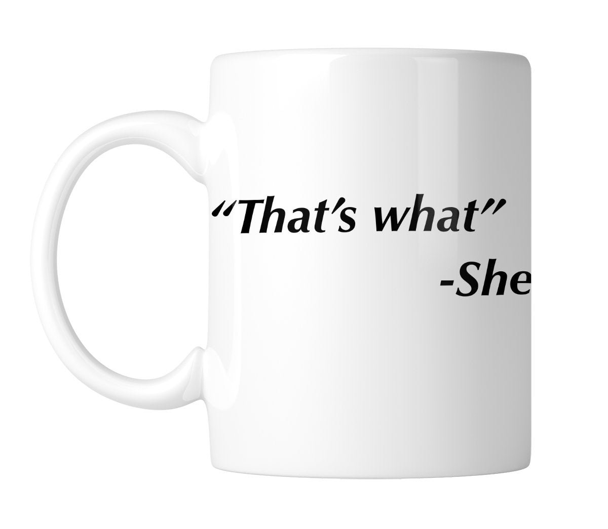 White mug printed with “That's what” – She in black italic text, handle on the left