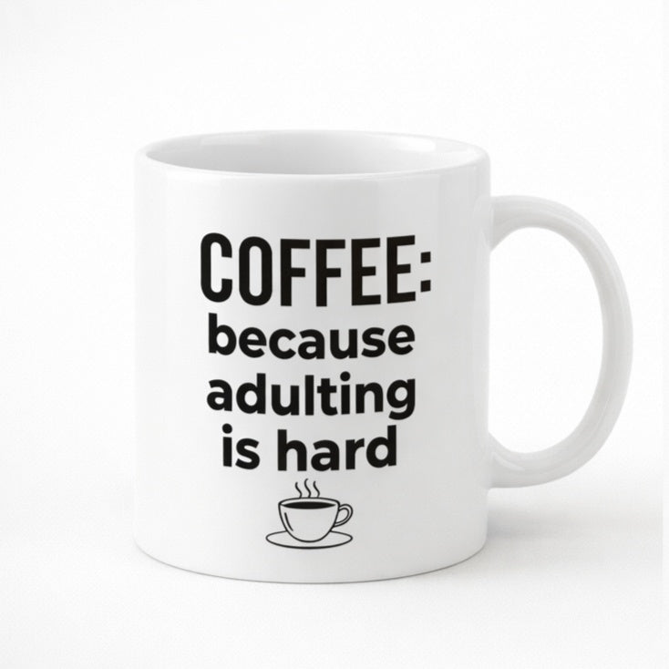 White mug printed “Coffee: Because Adulting Is Hard”